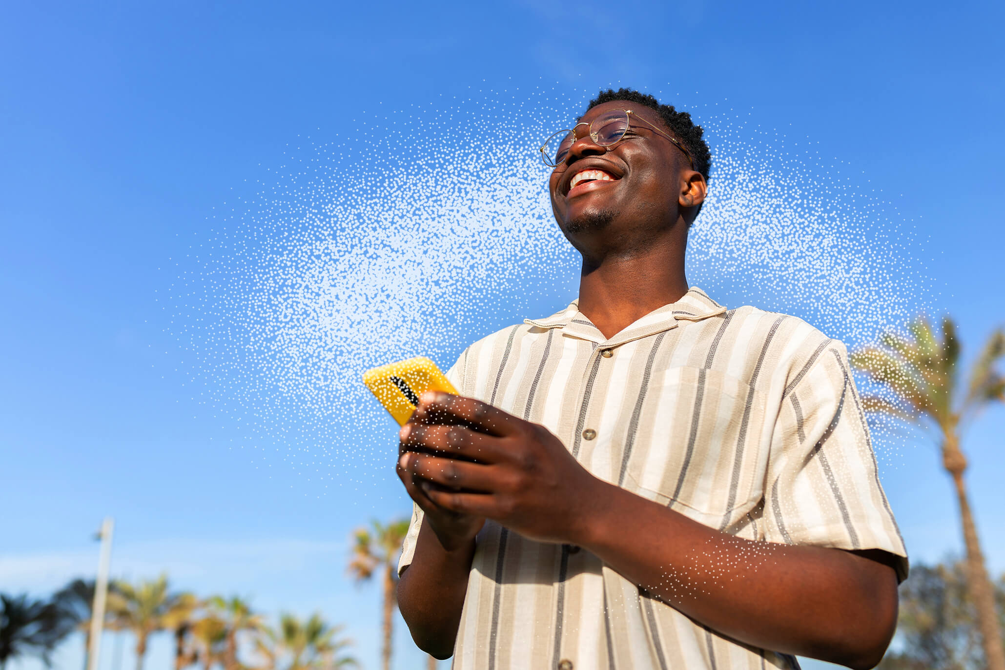 Smiling man holding phone