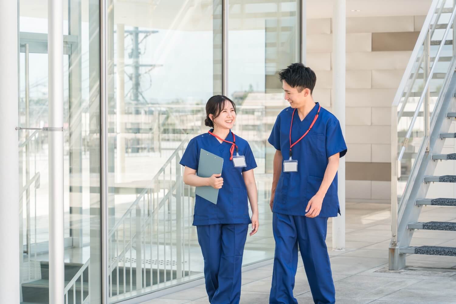 Two people in scrubs talking