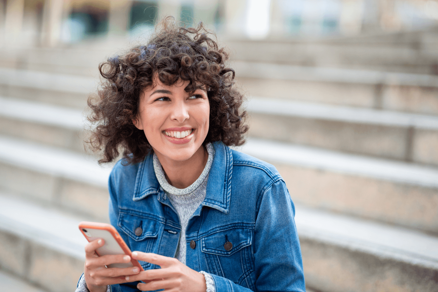 Smiling woman using phone
